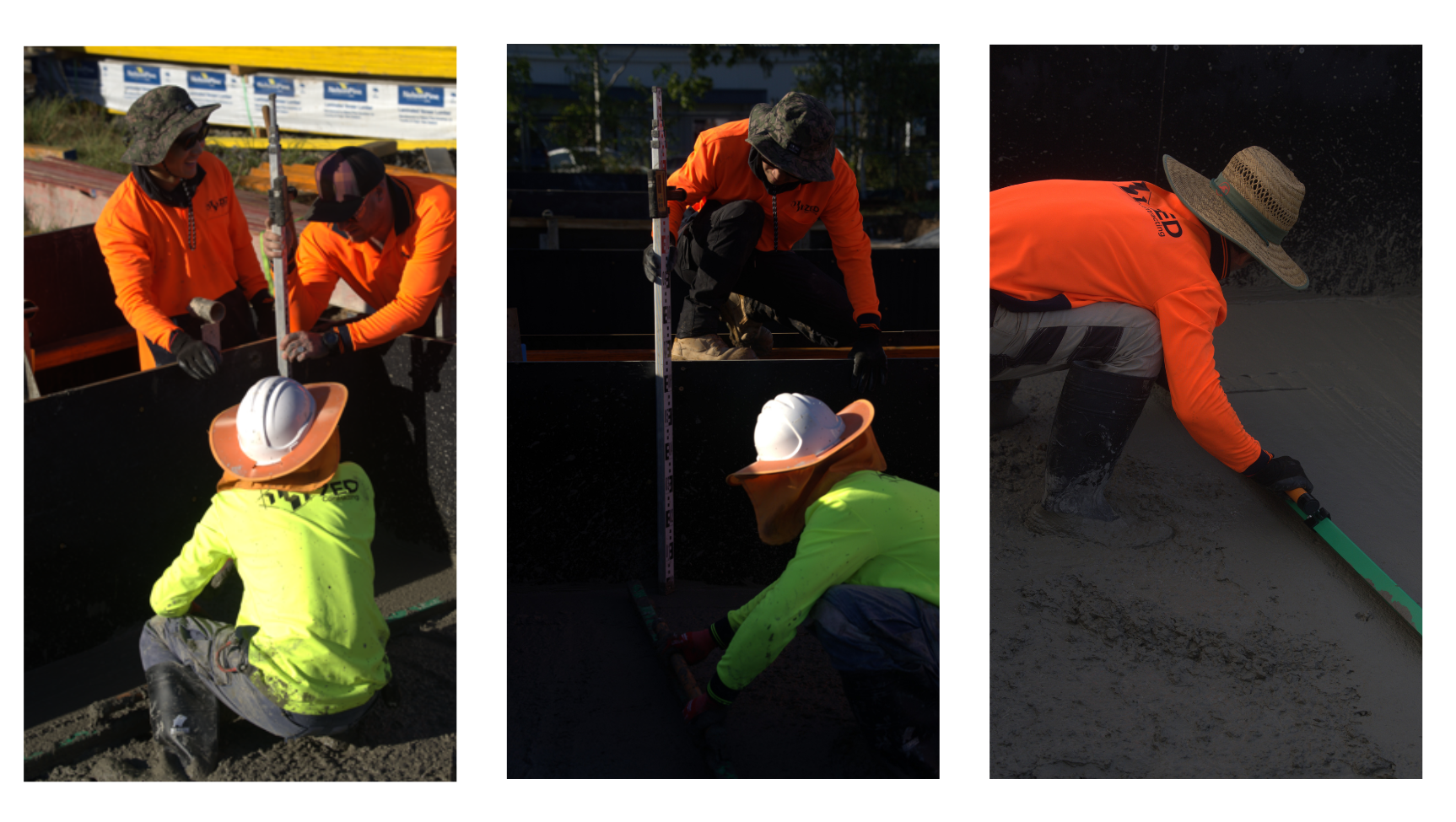 Three construction workers wearing bright safety clothing and hats are smoothing and leveling wet concrete at a worksite, using tools and working together in sunlight.